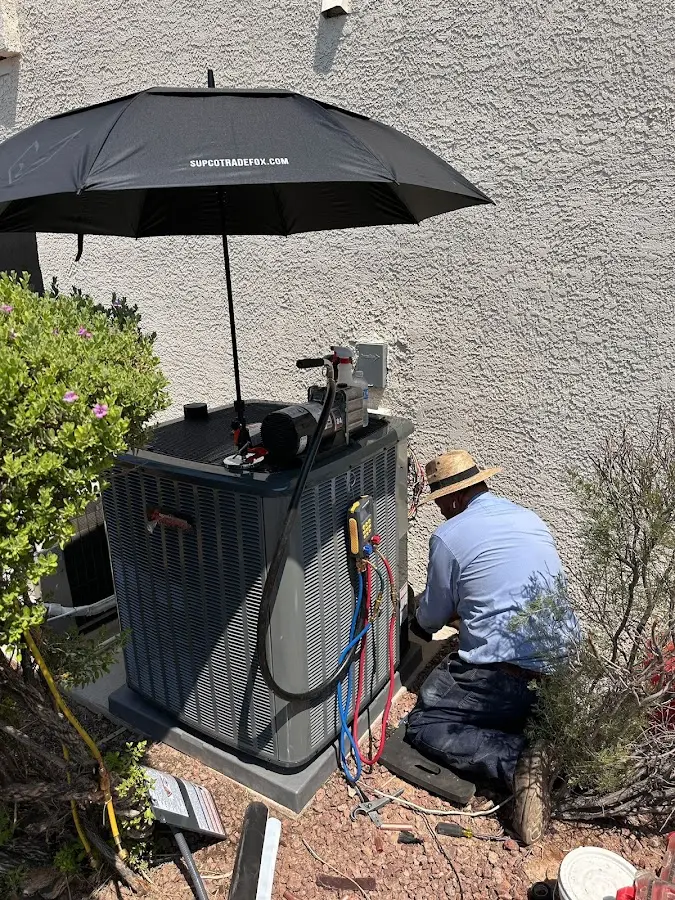 HVAC technician performing outdoor AC maintenance in Highlands